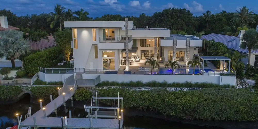 Luxury waterfront living with this striking modern architectural masterpiece. With its seamless blend of sleek design and natural elements, this home boasts expansive terraces and floor-to-ceiling glass walls providing panoramic views. Its elegant exterior is complemented by a private dock and lush landscaping, offering the perfect blend of comfort and sophistication for discerning homeowners seeking a peaceful retreat by the water.
