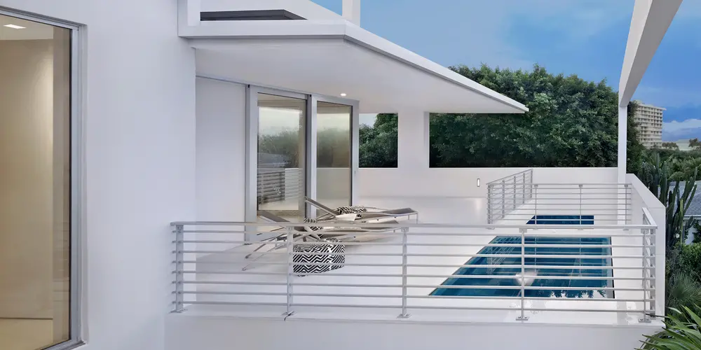 This contemporary balcony presents a sophisticated sanctuary with a private lap pool, where modern design meets serene outdoor enjoyment.