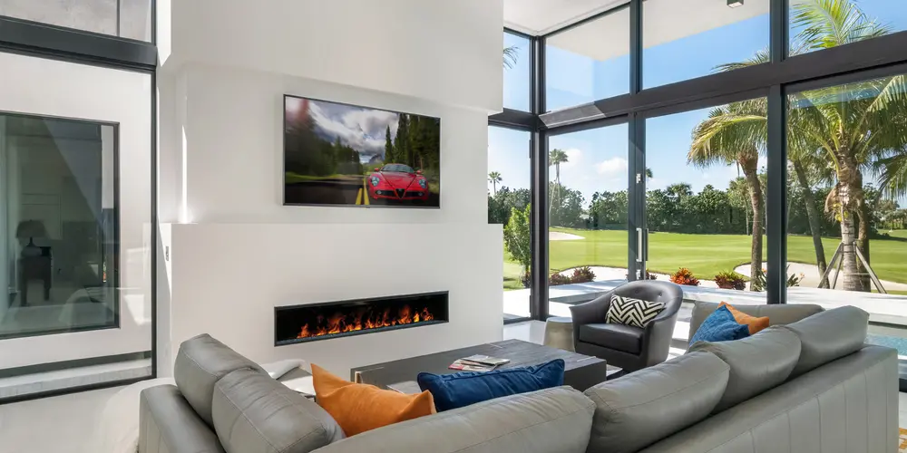 This modern living room is a blend of comfort and style, characterized by a harmonious color scheme and an abundance of natural light, offering a warm and inviting social space.