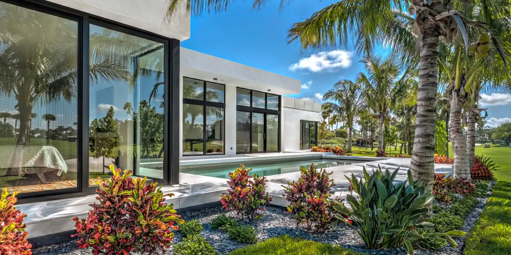 This detail of the poolside area perfectly encapsulates luxurious living, where modern architectural precision meets the lush vivacity of surrounding nature.
